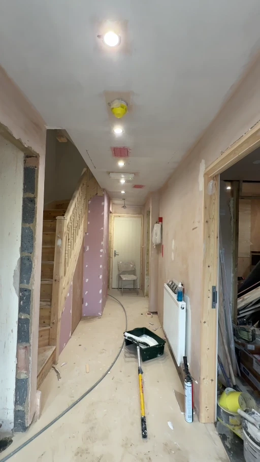 Hallway during preparation with exposed surfaces, tools and unfinished door frames